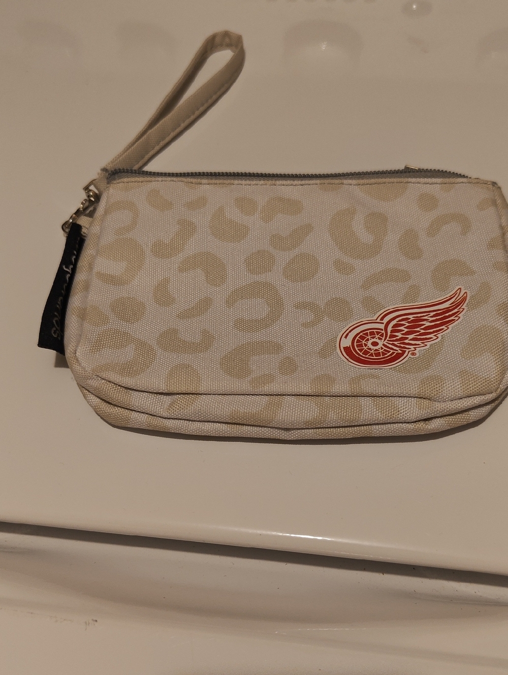 Beige Leopard Print Wristlet Pouch with Red Wing Emblem